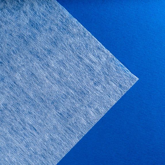 Type 2111 35gsm Superabsorbent Thermo-Carded Fabric shown flat on a blue background