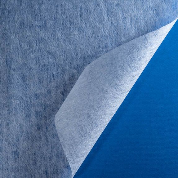 Type 2111 35gsm Superabsorbent Thermo-Carded Fabric shown folded on a blue background