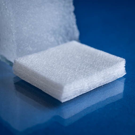 Type 2654 620gsm Superabsorbent Airlaid Fabric with a nonwoven laminate bottom layer. Close up of dry fabric swatch