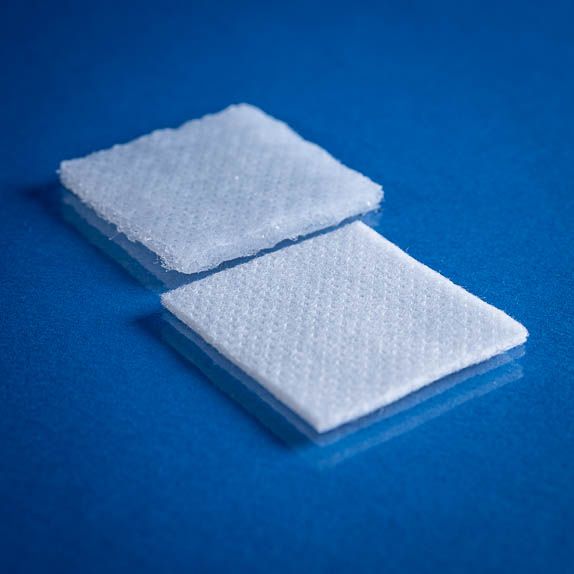 Type 2786 190gsm Washable Superabsorbent Needlepunch Nonwoven Fabric with top and bottom laminates on blue background