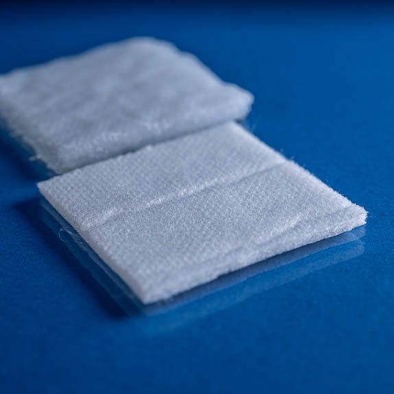 Reusable Needlepunch Nonwoven Fabric 2827 shown dry and saturated on a blue background close up 574 x 574px