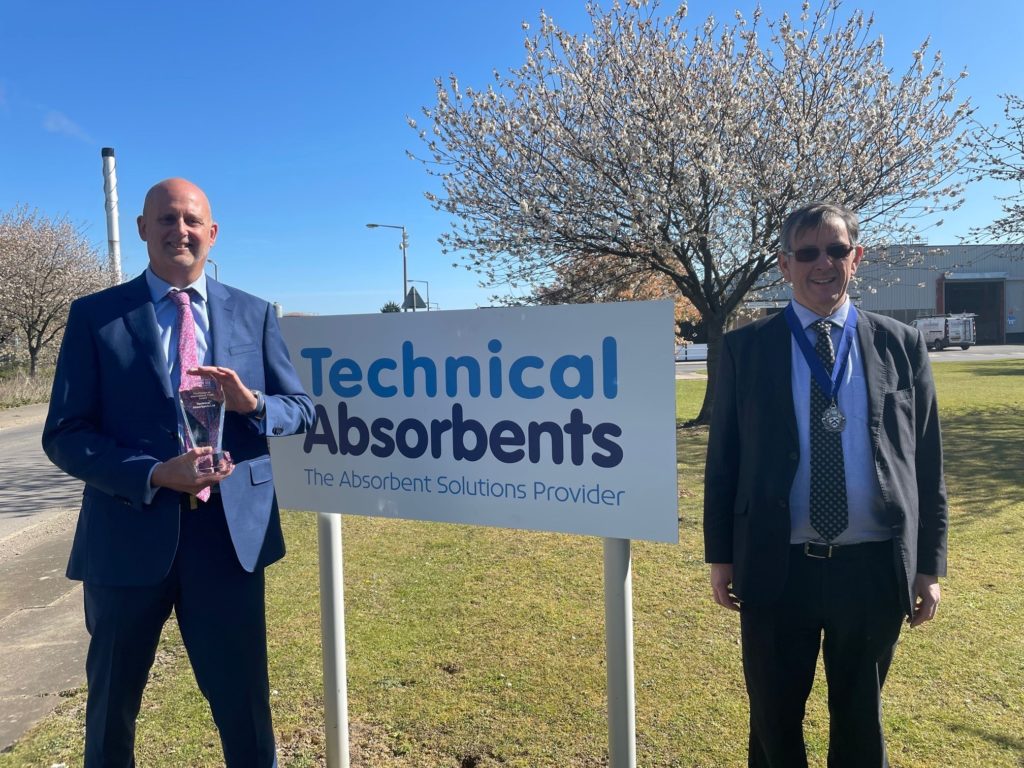 Techincal Absorbents owners stood next to sign